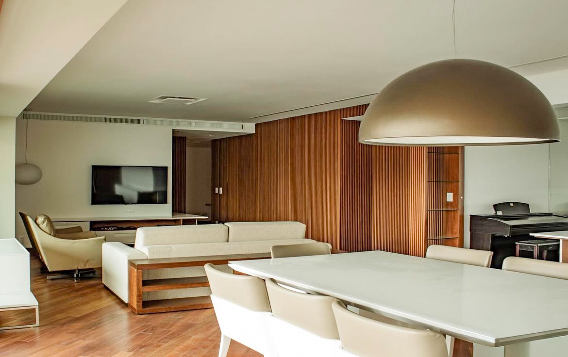 Living integrado com piano e painel ripado de madeira